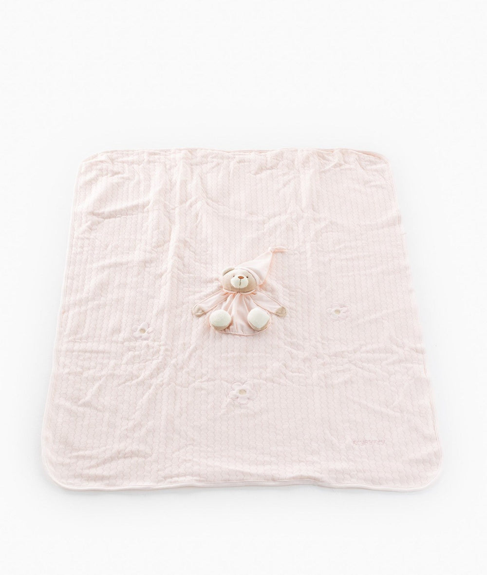 Spread out pink baby blanket with embossed floral pattern and centered bear