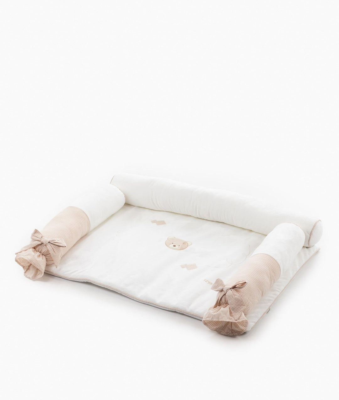 Angled view of 4pc change mat set with white bolsters and beige gingham bows