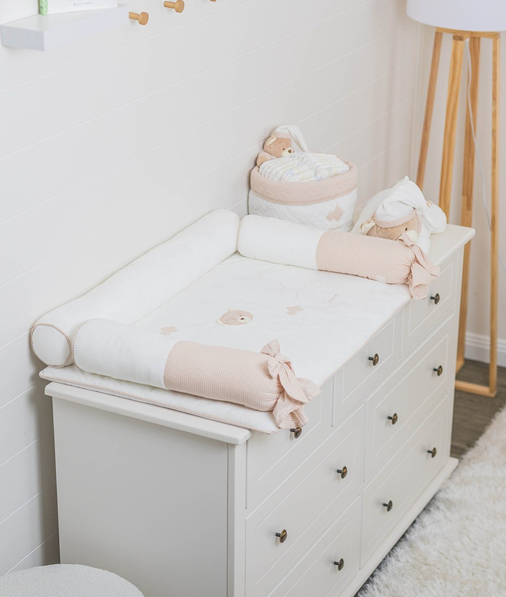 Lifestyle shot of beige and white change mat set styled on nursery dresser