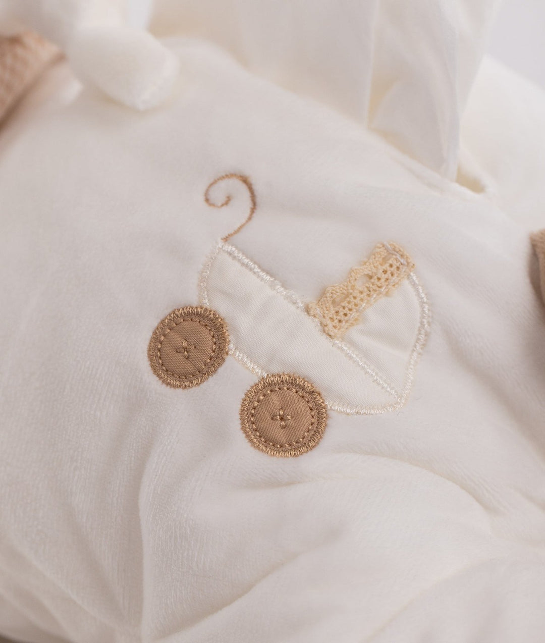White soft bear nappy organizer featuring embroidered tan pram design detail