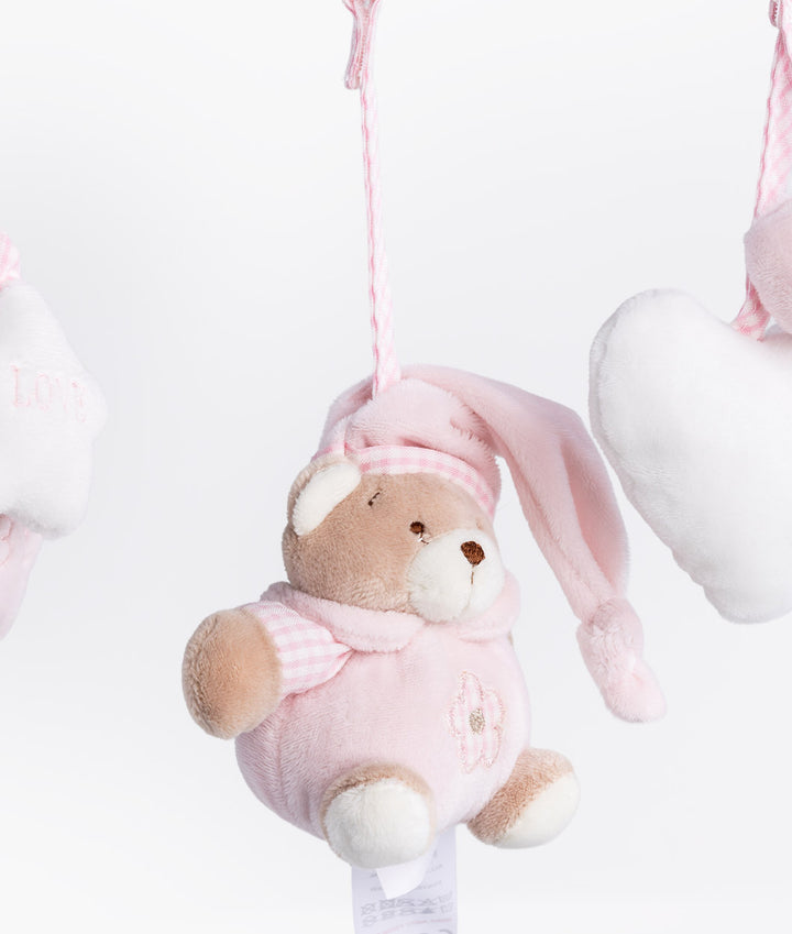 Close up of pink plush bear wearing gingham bunny hat hanging from twisted cord