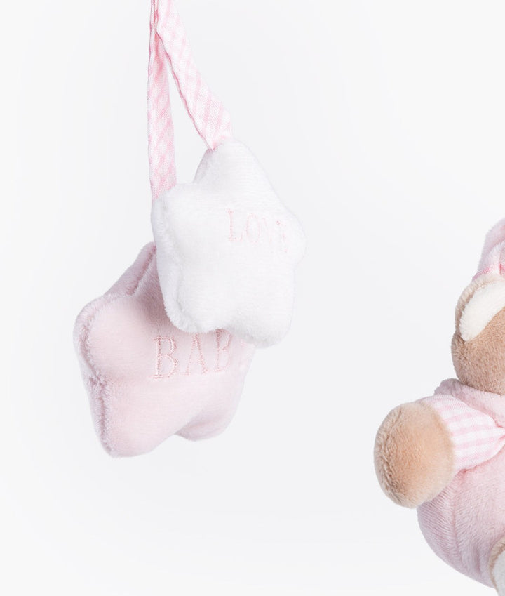 Macro view of pink and white star charms with LOVE BABY embroidery on gingham strap