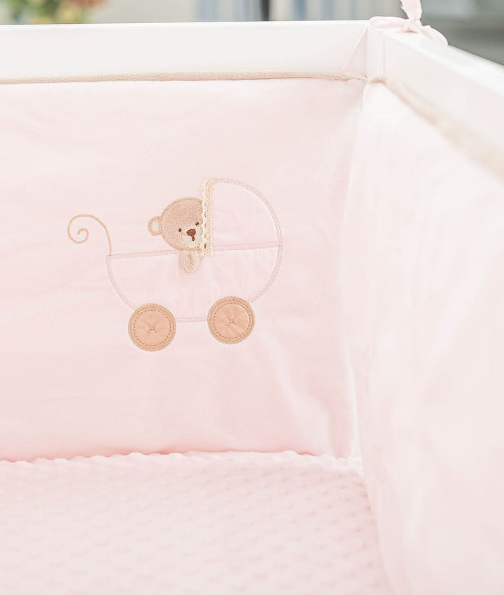 Double-sided cot bumper detail with embroidered teddy bear in pram design