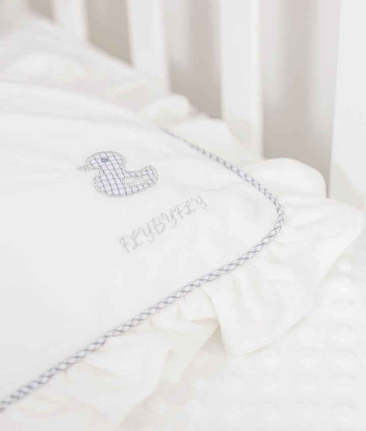 white pillow corner with blue gingham duck patch and FLYBYFLY embroidery