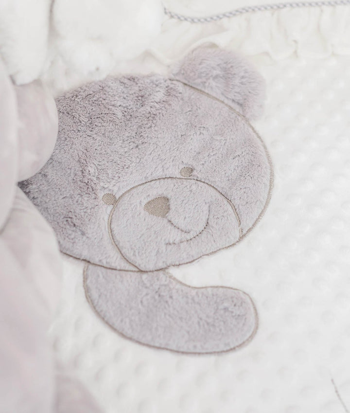 grey fuzzy teddy face applique on white textured dot fabric with piping trim