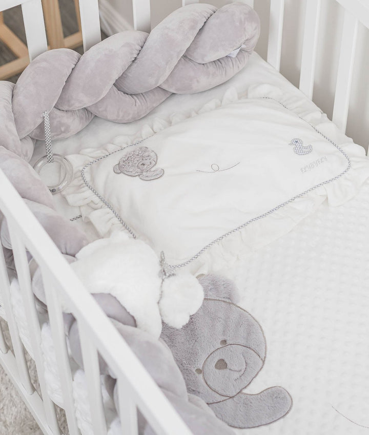 grey velvet bolster and ruffled pillow with bear duck embroidery in crib