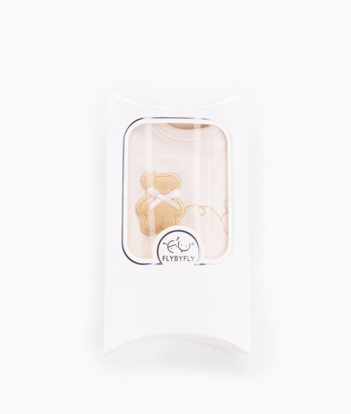 FLYBYFLY pink baby bib in retail packaging with clear window showing teddy bear applique and brand seal