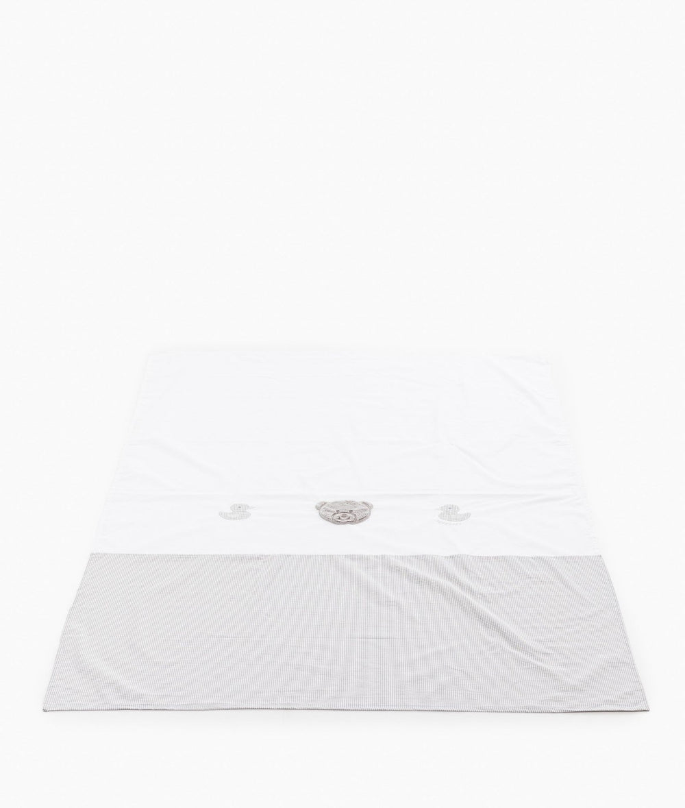 White cotton flat sheet with grey gingham border and central plush teddy bear design