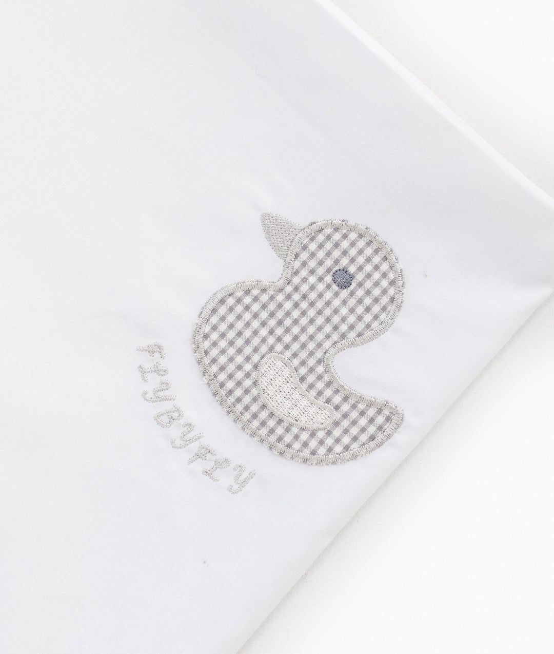Grey gingham duck applique detail on white cotton flat sheet with FLYBYFLY logo