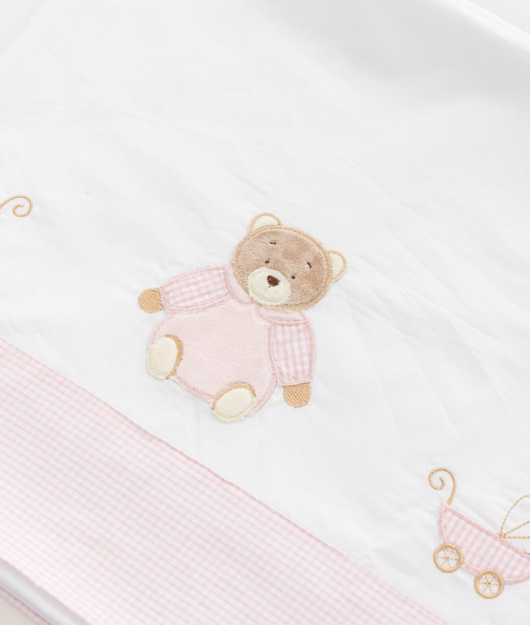 Close-up of 100% cotton texture and teddy bear embroidery