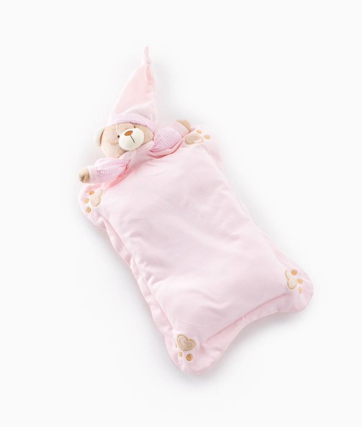 Front angle pink contoured baby pillow shaped like sleeping teddy bear with embroidered paw prints