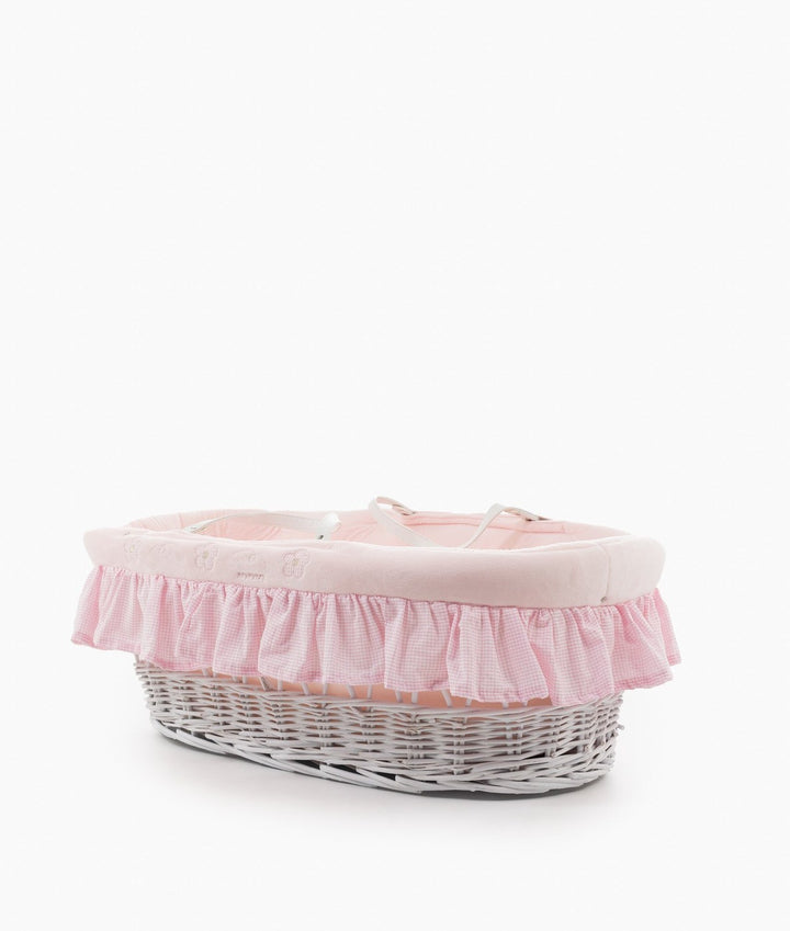 White wicker Moses basket with pink cotton liner and safety straps
