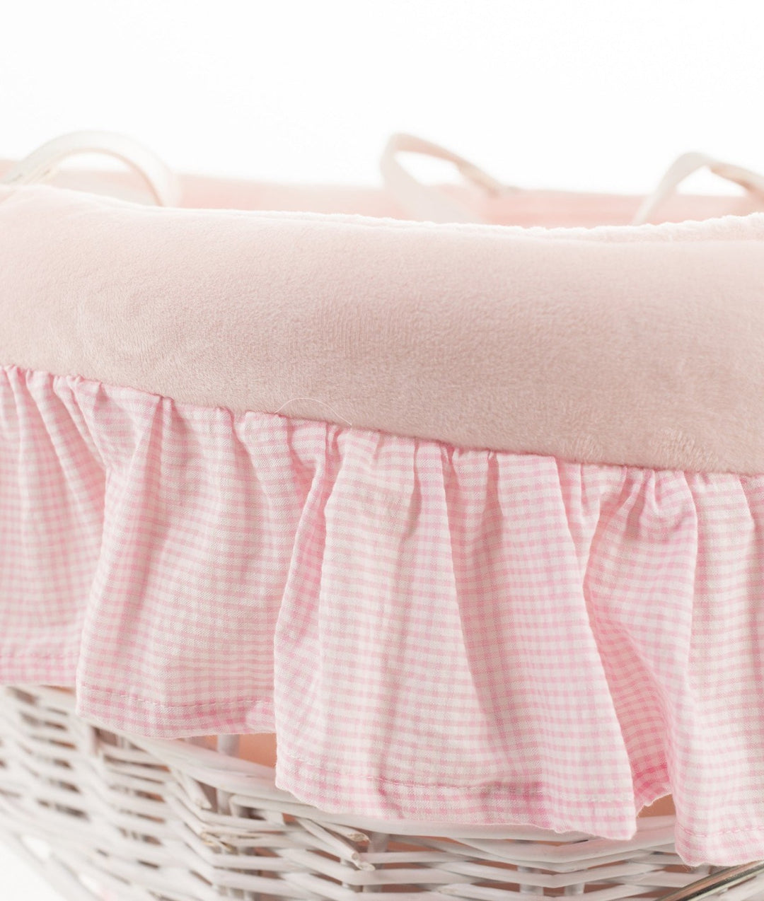 Close up of plush pink rim and gathered gingham ruffle trim on Moses basket