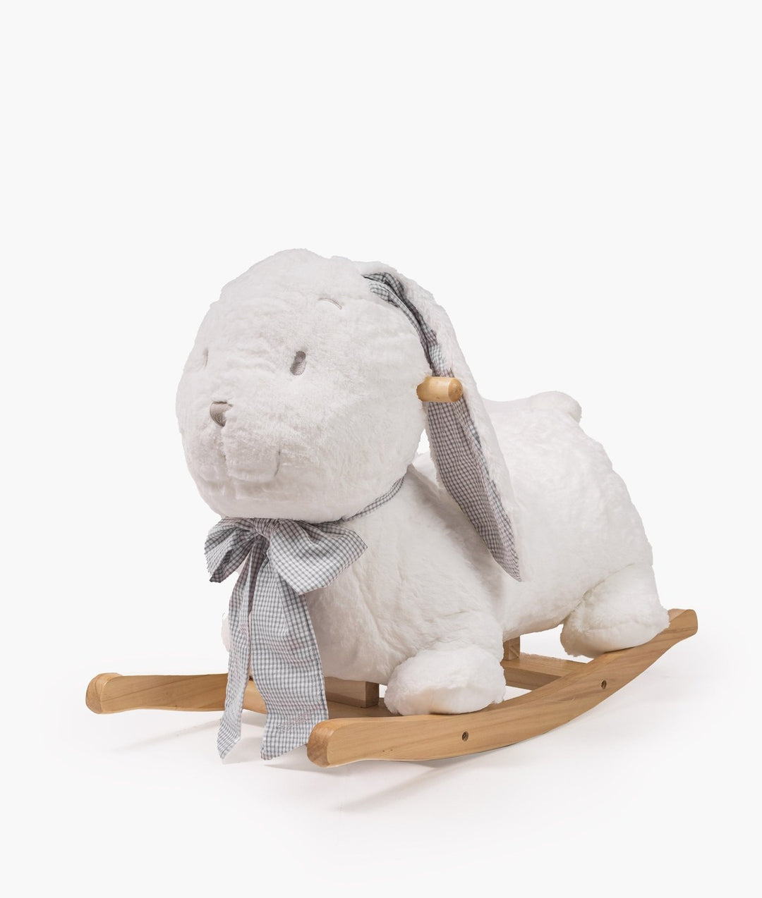 Three quarter angle of white plush rocking bunny showing curved natural wood base and checkered bow tie