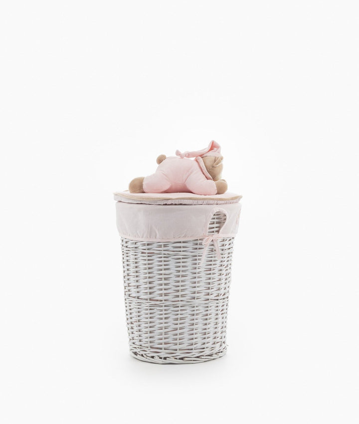 Tall white wicker nursery basket with pink liner and teddy bear lid
