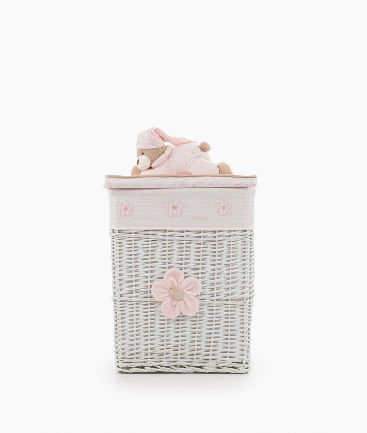 White wicker basket with large pink fabric flower and sleeping teddy bear