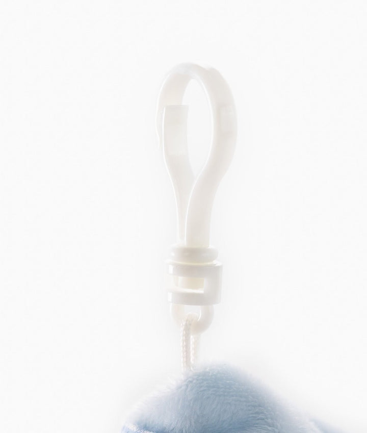 Close-up of white plastic clip hook on blue plush baby stroller charm