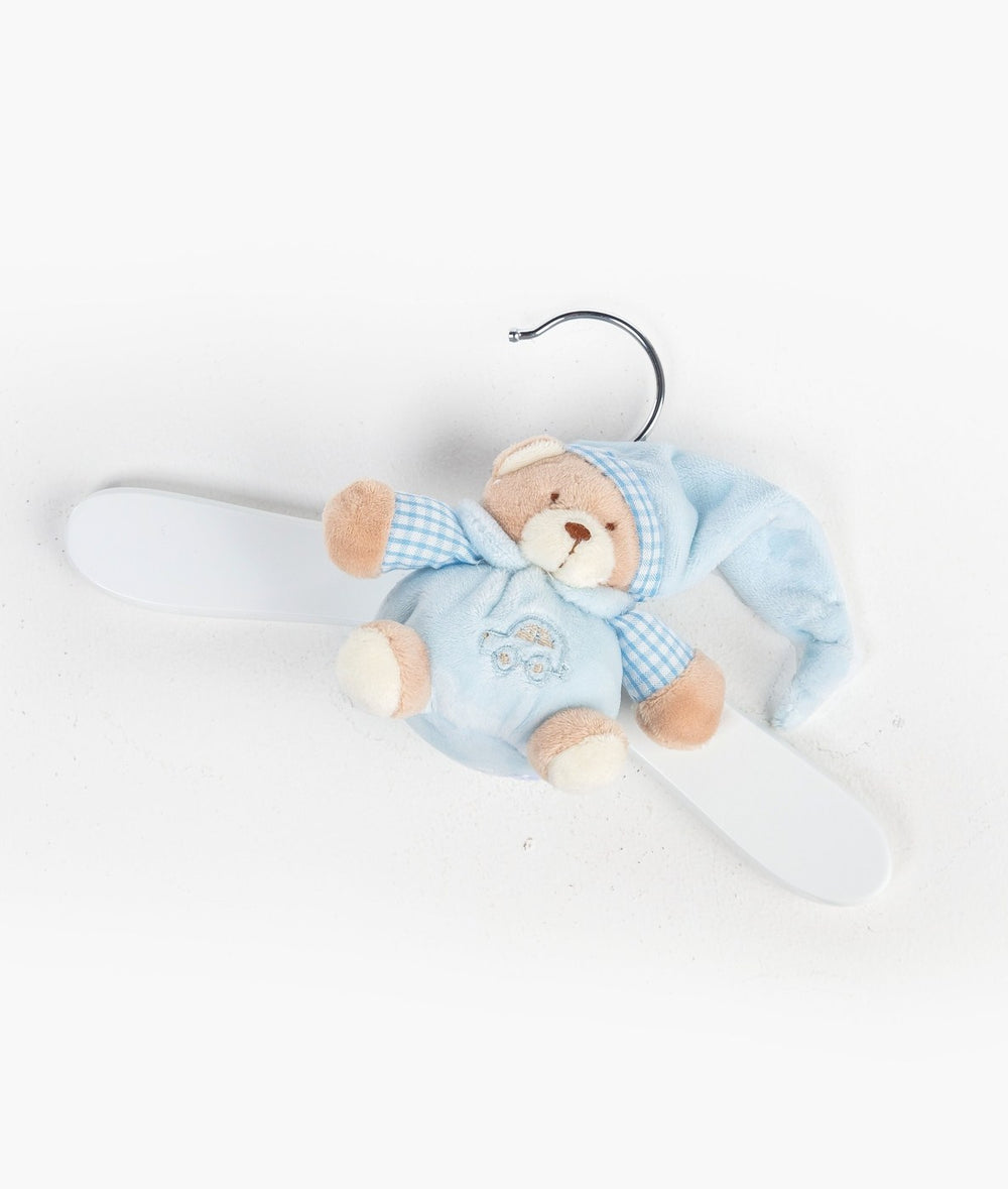 Top-down flat lay of blue teddy bear wooden hanger on white background