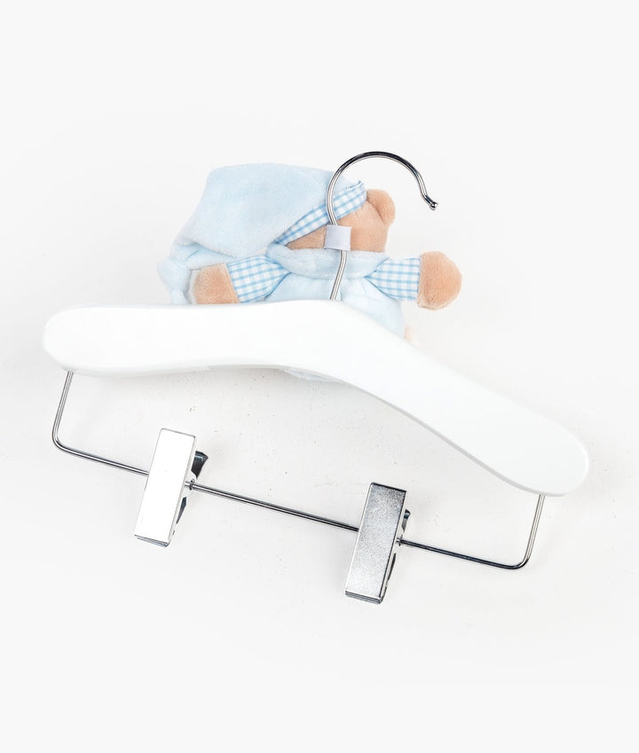 Back view of white wooden baby hanger with silver metal clips and teddy bear